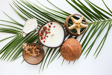 original handmade soy wax candle in coconut, palm branch and sea shells. marine theme