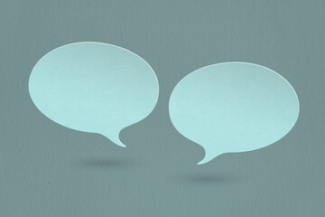 two blank blue speech bubble paper cut, on grunge dark blue paper background including clipping path. Conceptual image about communication and social media