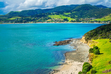 Aerial view over Hokianga Harbour surrounded by lush green hills and sandy beaches. Iconic New Zealand, Northland