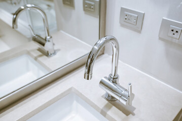 Bathroom interior with sink and faucet.