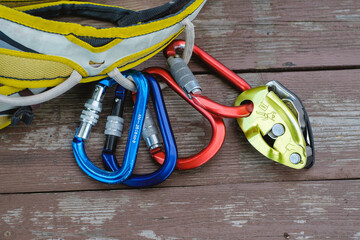 Climbing equipment on wooden background
