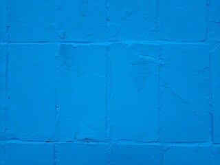 Blue painted wall. Textured background with tiles.