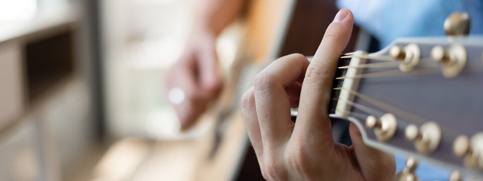 Playing guitar close up. selective focus image. Banner image.