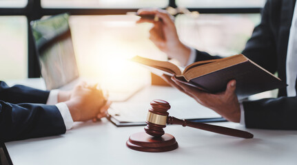 concept of justice and law A male judge in the courtroom on a wooden table and a male counselor or...