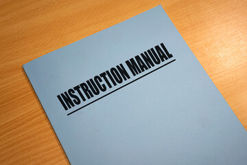A product instruction manual text book document which is placed on wooden table. Business working...