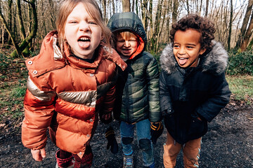 children in winter making faces at the camera