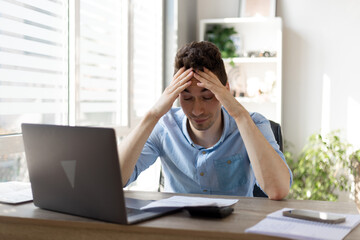 Businessman office working holding sore head pain from desk working and sitting all day using laptop computer or notebook suffering headache sick worker overworking concept.