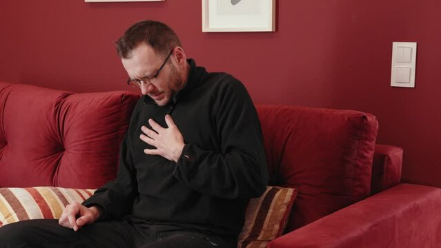 The man has a heart attack and is calling for help.