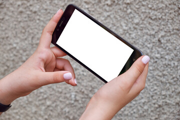 Young girl holding smartphone with white screen - 519760286