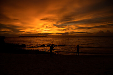 Couple at the Beach ---   picture of a couple making photos at sunset on a beach in Thailand