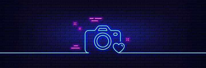 Neon light glow effect. Photo camera line icon. Love photography sign. Heart symbol. 3d line neon glow icon. Brick wall banner. Photo camera outline. Vector