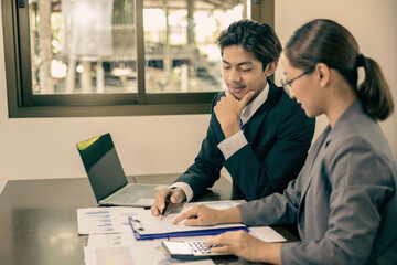 Two business leaders talk about charts, financial graphs showing results are analyzing and calculating planning strategies, business success building processes