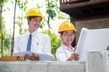 Team of male and female engineers and architects, working team, meeting, discussing construction, and inspecting the outdoor construction site work