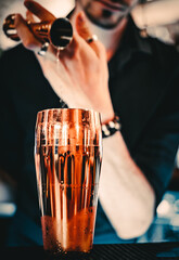 man hand bartender making cocktail with shaker on the bar counter