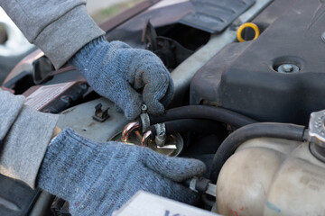 Mechanic working under the hood of a car, close-up