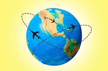 Global transportation. Globe of Earth with a silhouette of an airplanes flying along the routes. Yellow background. The concept of air travel