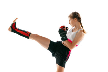 Junior female MMA fighter in sports uniform and gloves training isolated on white background....