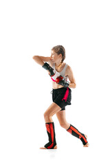 One sportive teen-girl, professional MMA fighter in action, motion isolated on white background. Concept of sport, competition, action, healthy lifestyle.