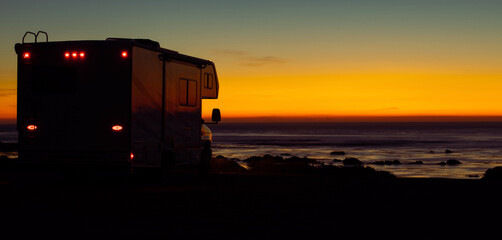 RV Camper Van and the Scenic Beach Sunset