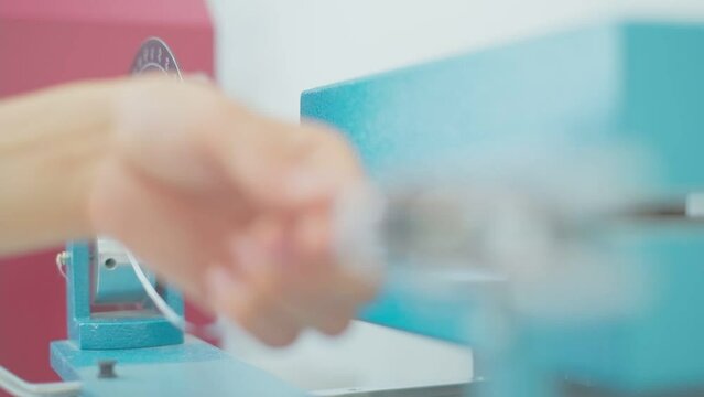 Closeup of polymer thread for plastic sack bags is installed to strength test machine