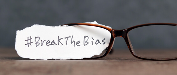 Torn paper with the word ‘BreakTheBias' written on it. Break the bias campaign.
