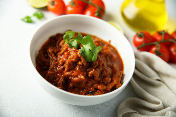 Homemade beef ragout with cilantro and lime