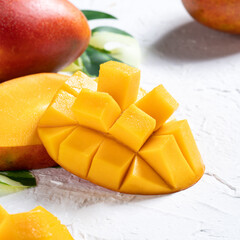 Mango background design concept. Top view Diced fresh mango fruit on white table.