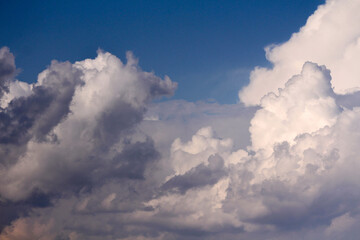 Fototapeta na wymiar Fluffy voluminous white clouds in a blue sky