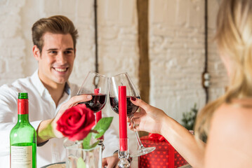 couple celebrating Valentine's day toasting in a dinner at home
