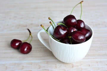 ripe dark cherries in the cup, close-up
