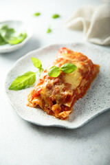 Traditional homemade lasagna with fresh basil