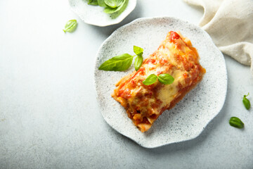 Traditional homemade lasagna with fresh basil