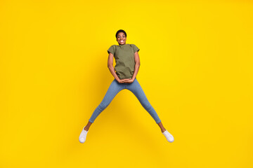 Fototapeta na wymiar Full length photo of cheerful excited person jump have fun good mood isolated on yellow color background
