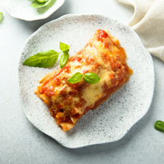 Traditional homemade lasagna with fresh basil