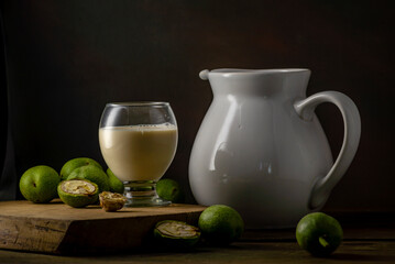 green walnut kernels leaves  wooden table oil nuts unripe husks healthy food drink, old rustic table Background Harvest, organic Homemade plant based milk Dairy free  jug glass cup