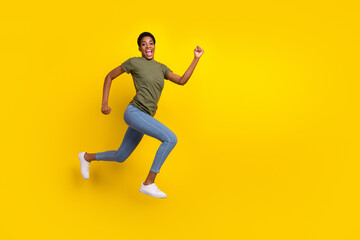 Fototapeta na wymiar Full size photo of excited sportive person jump rush hurry fast isolated on yellow color background