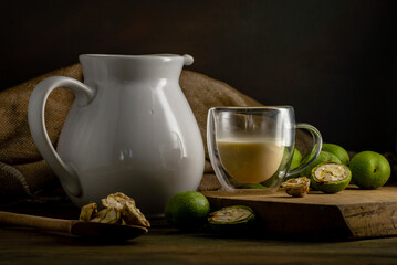 green walnut kernels leaves  wooden table oil nuts unripe husks healthy food drink, old rustic table Background Harvest, organic Homemade plant based milk Dairy free  jug glass cup