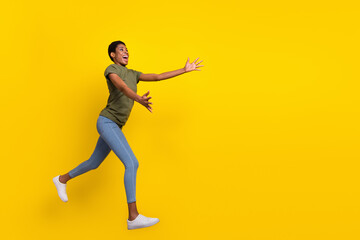 Fototapeta na wymiar Full length photo of funky excited person jump opened arms catch expect empty space isolated on yellow color background