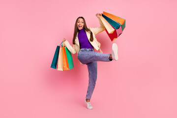 Full size photo of success brunette young lady hold bags yell wear trend cloth boots isolated on pink color background