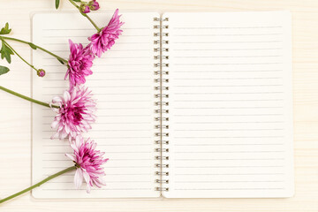 The notebook on the desk and the dahlias