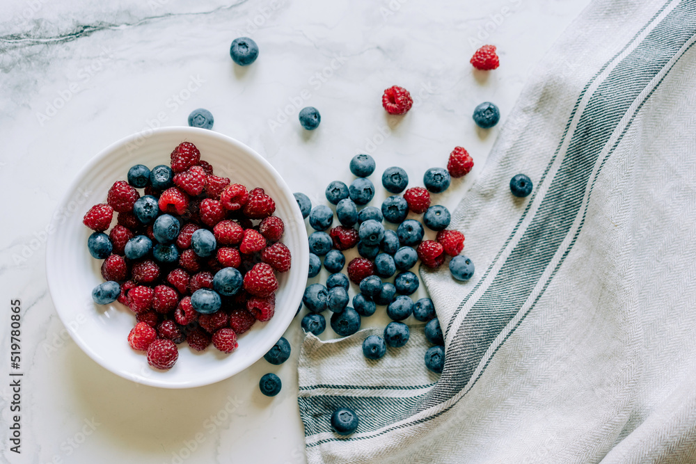 Wall mural top view of pile of fresh and healthy and berries for wellness on marble background.