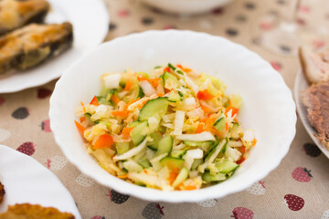 chopped cabbage, tomatoes, cucumbers, onions and herbs in a bowl