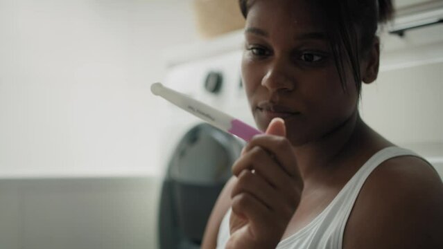 Close up of African-American stressed woman  waiting for pregnancy test results. Shot with RED helium camera in 8K.    