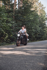 Young couple on a motorcycle no helmet ride on the road at high speed, dangerous driving, in motion