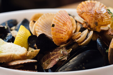 A seafood plate of delicious Adriatic catch of the day  - lobster, prawns, shrimps, oysters, mussels, shells, octopus and calamari in wine buzara sauce