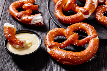 pretzels in the form of knot with cheese sauce