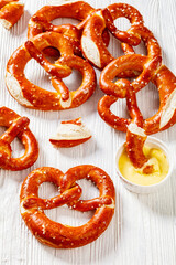 pretzels in the form of knot with cheese sauce