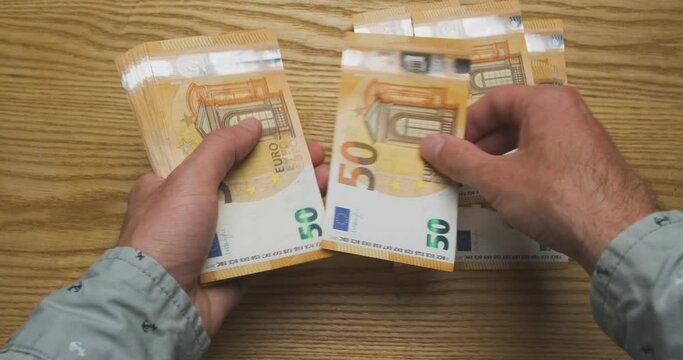 Men's hands quick count money, cash euro. Top view from the first person, fast, speed. Concept of getting a salary, credit, work, taxes, finance, payment for services, high price