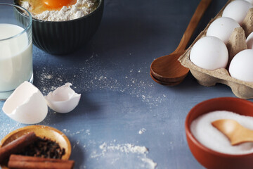 Food ingredients for baking: flour, eggs, milk, sugar