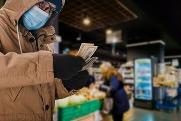 Portrait of man in safety medical mask holding big cash money pack, elderly people during a pandemic